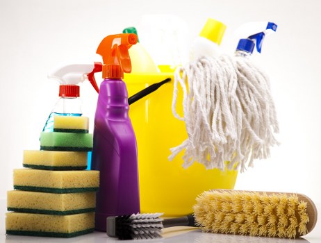 Cleaner using protective equipment while working with supplies