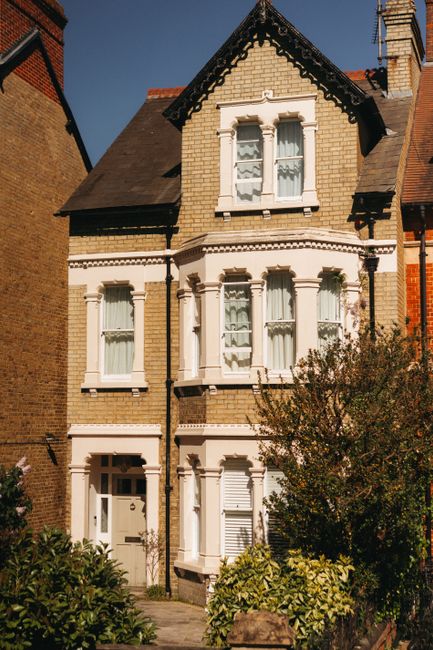 A tall, multi-storey Victorian-style residential building with a brick façade, positioned on Brownhill Road, featuring large sash windows with white frames and decorative molding. The building has a 